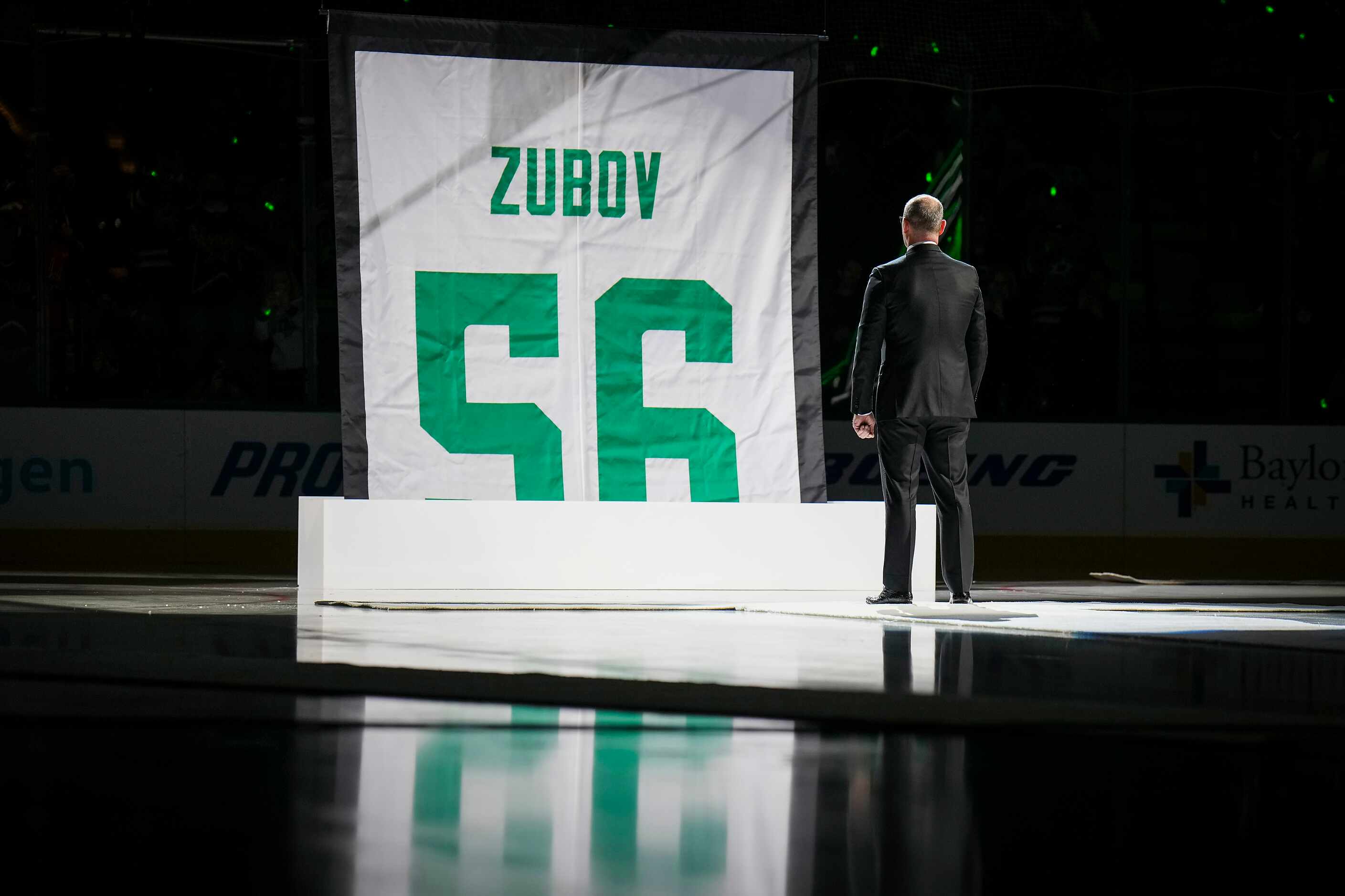 Former Dallas Stars player Sergei Zubov watches as a banner bearing his number 56 is raised...