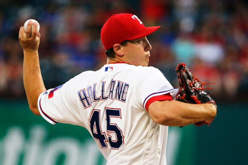 Texas Rangers starting pitcher Derek Holland (45) throws a first-inning pitch during the Los...