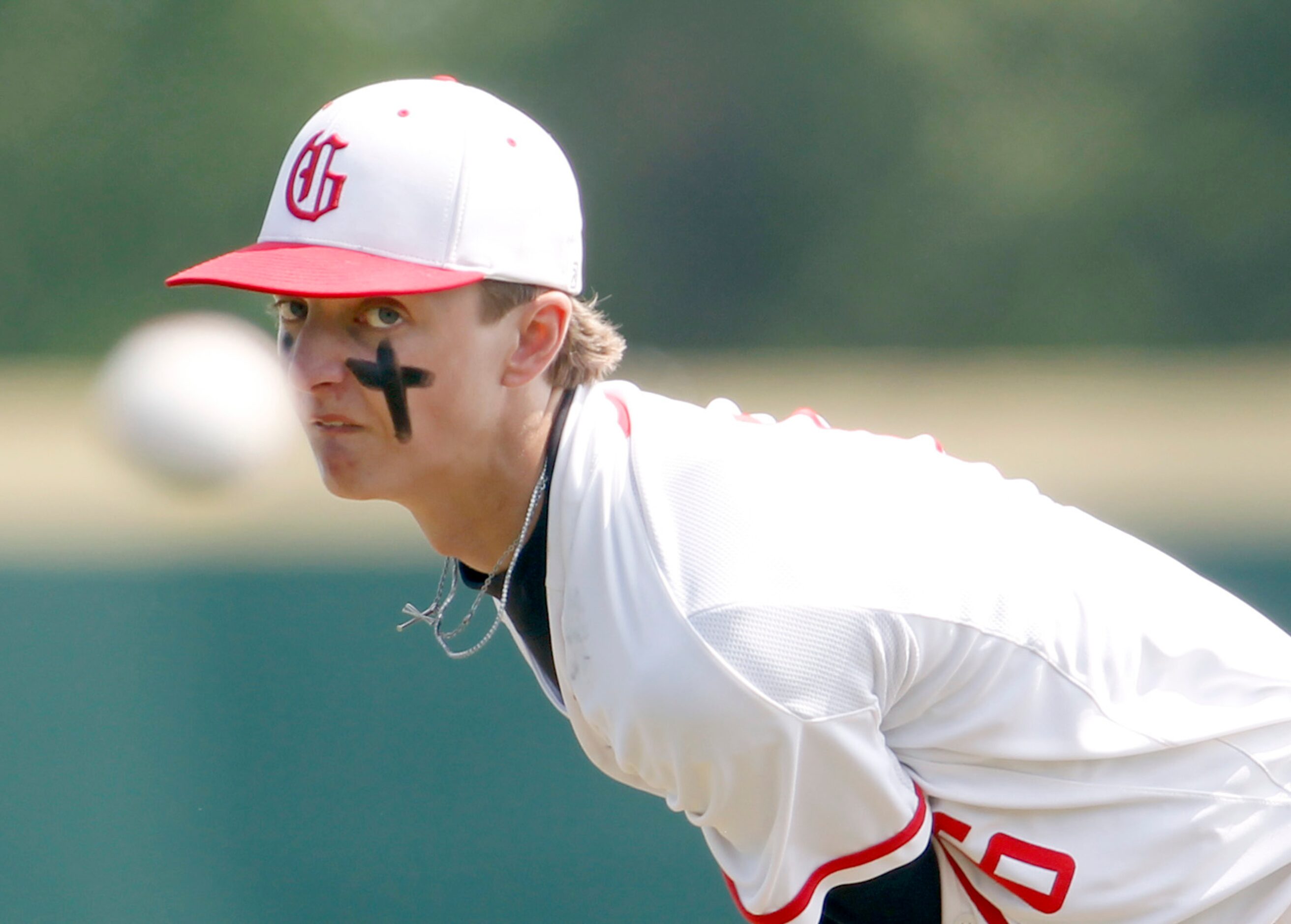 Grapevine pitcher Dasan Hill (6) watches a pitch hurled toward a Midlothian Heritage batter...