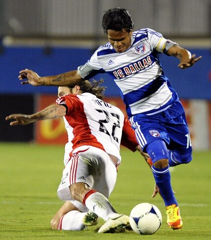 FC Dallas midfielder David Ferreira (10) dribbles around Toronto FC midfielder Torsten...