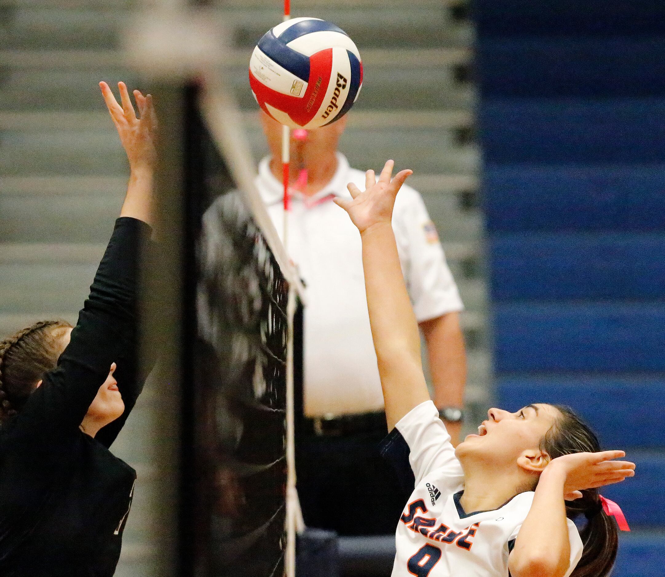 Sachse High School setter Claire Romo (9) goes up for the ball at the net during game one as...