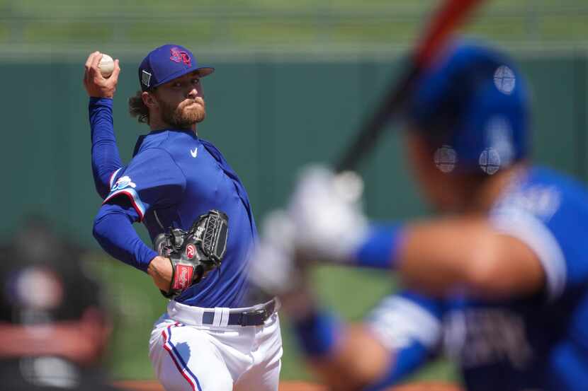 Texas Rangers pitcher Jake Latz delivers during the first inning of a spring training game...