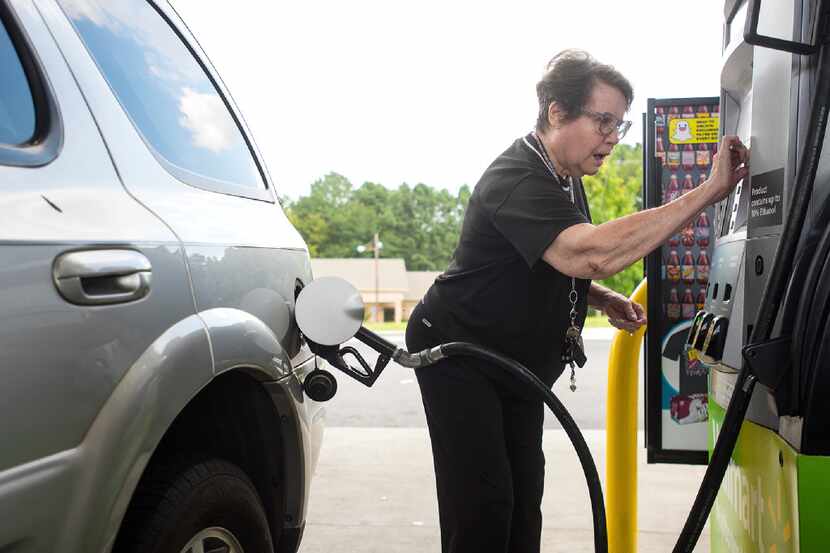Dollie Chase inserts her card to pay for gas at a Walmart in Tyler.