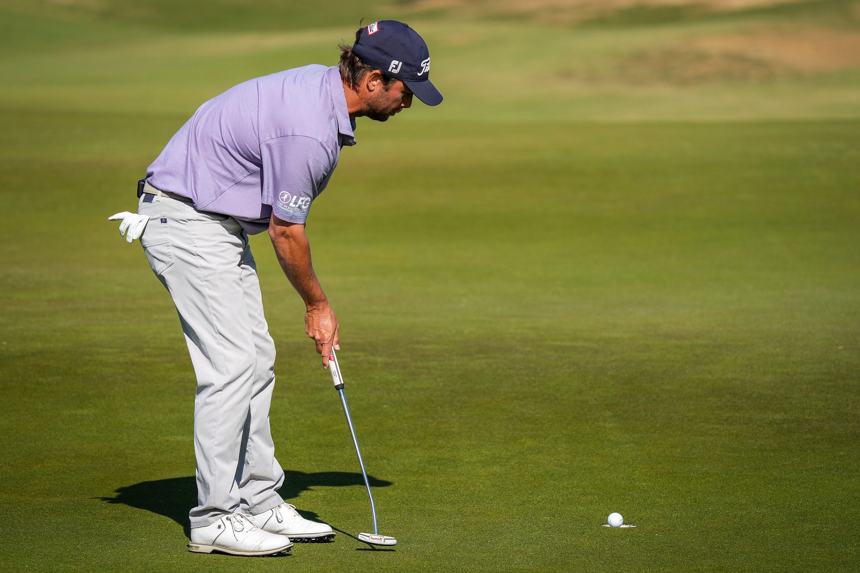 Spencer Levin sinks a putt for birdie on the 18th hole during the final round of the Korn...