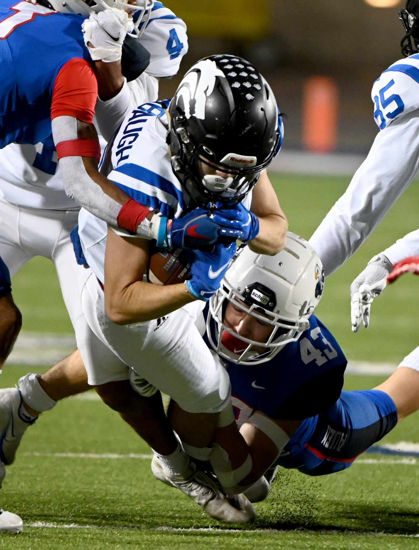 Plano West’s Jackson Stambaugh is tackled by Allen’s Aidan Graham (43) in the first quarter...