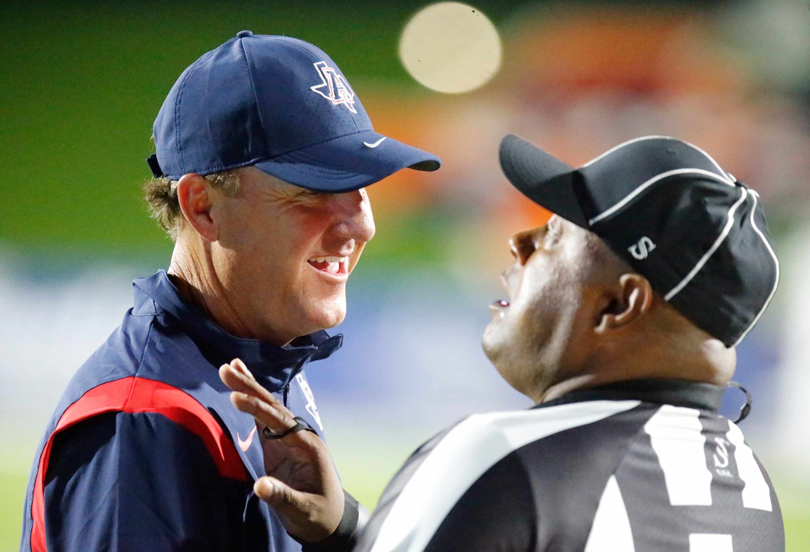 Allen High School head coach Chad Morris talks with a ref about a play during the first half...