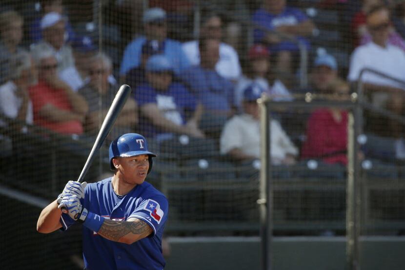 Texas Rangers outfielder Michael Choice prepares for an at bat in the on deck circle during...