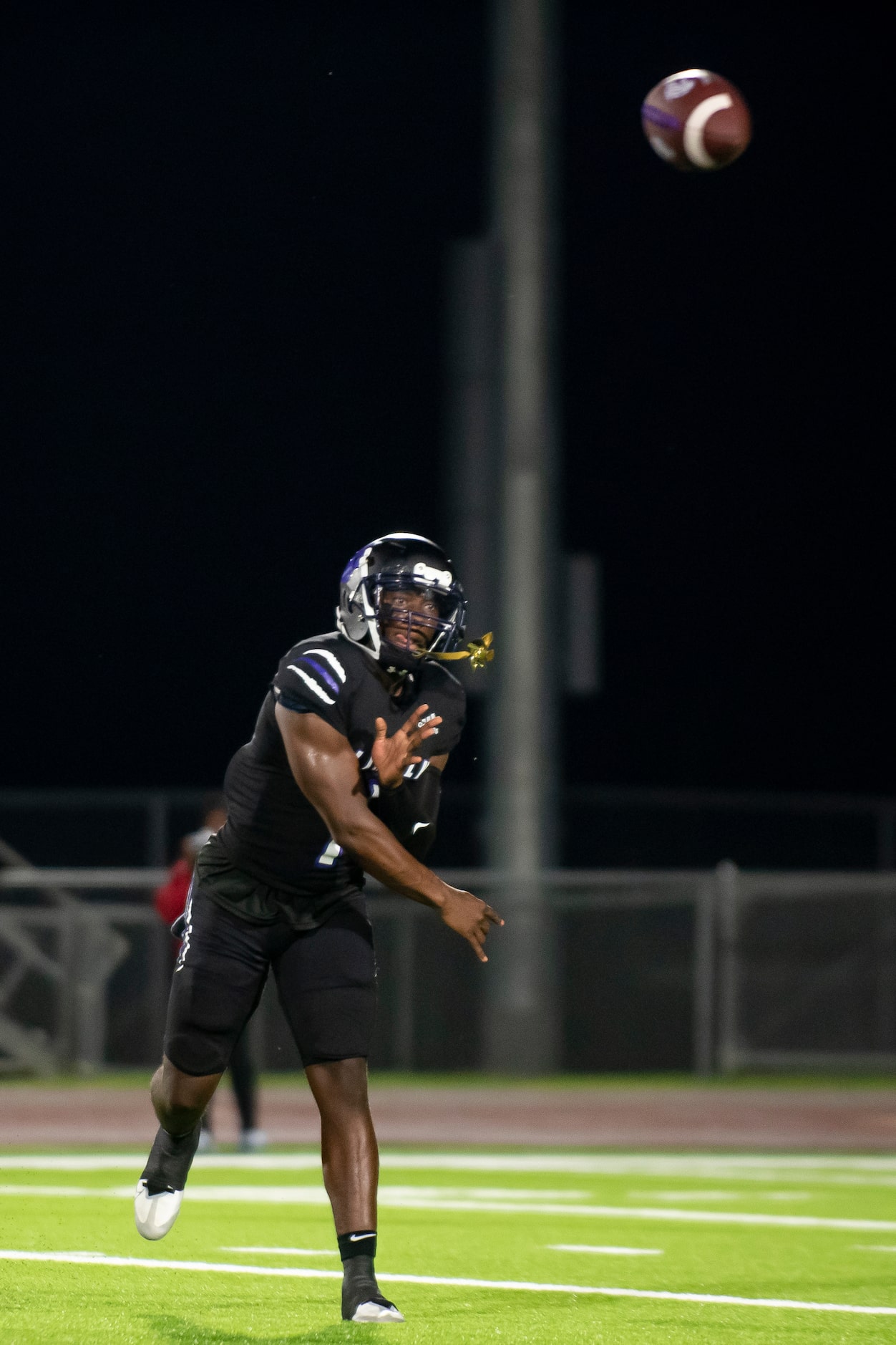 Lincoln senior Jaden Cole (1) passes the ball to a teammate during a high school football...