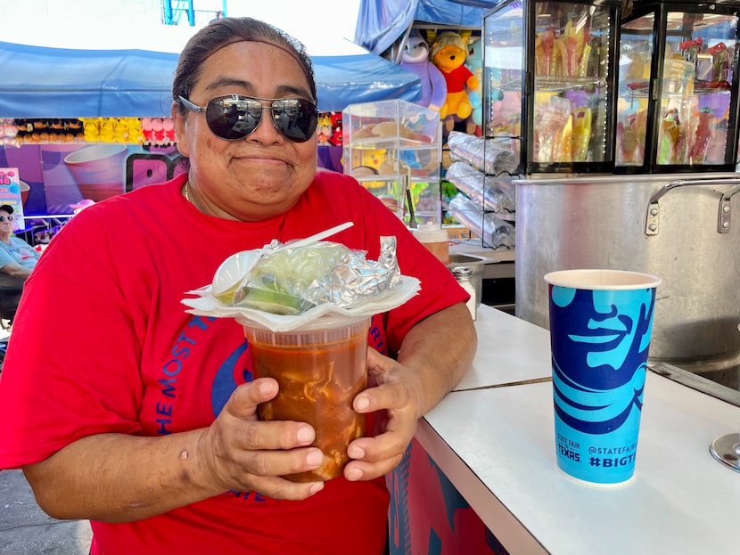 Carmen García holds a container of menudo she bought at Lupita's Gorditas, in the Midway...