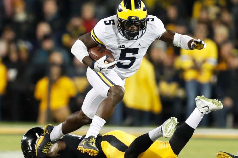 FILE - In this Nov. 12, 2016, file photo, Michigan's Jabrill Peppers (5) breaks a tackle by...