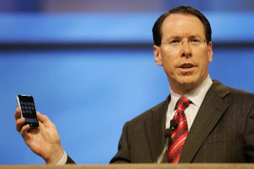 AT&T's Randall Stephenson, at that time the company's chief operating officer, shows off the...