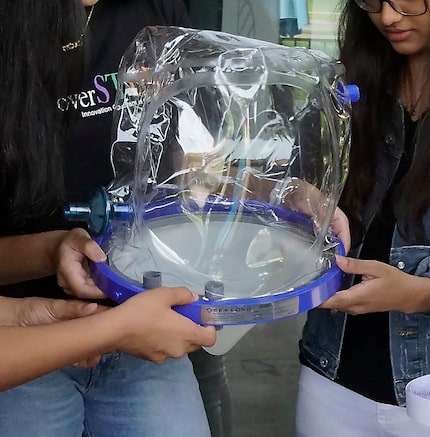 Mirza Faizan (not shown) is working with his DiscoverSTEM Academy mentees on a helmet to...