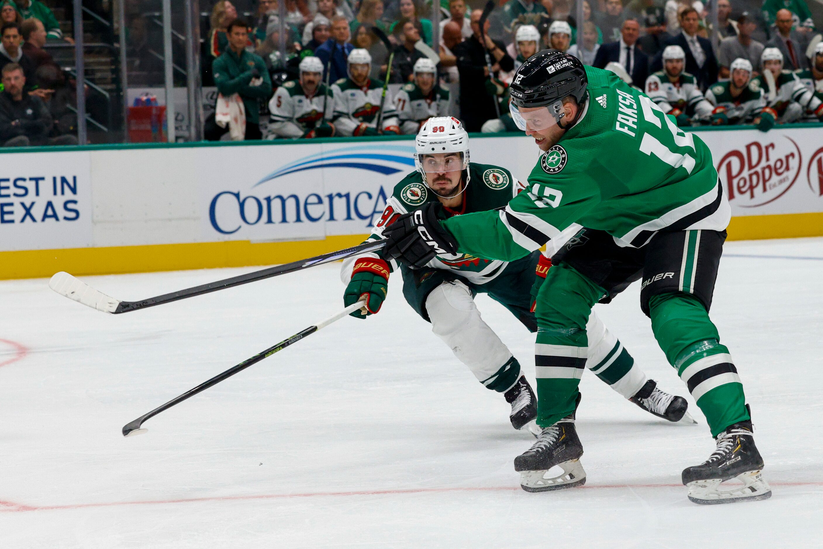 Dallas Stars center Radek Faksa (12) fires a shot towards goal past Minnesota Wild left wing...