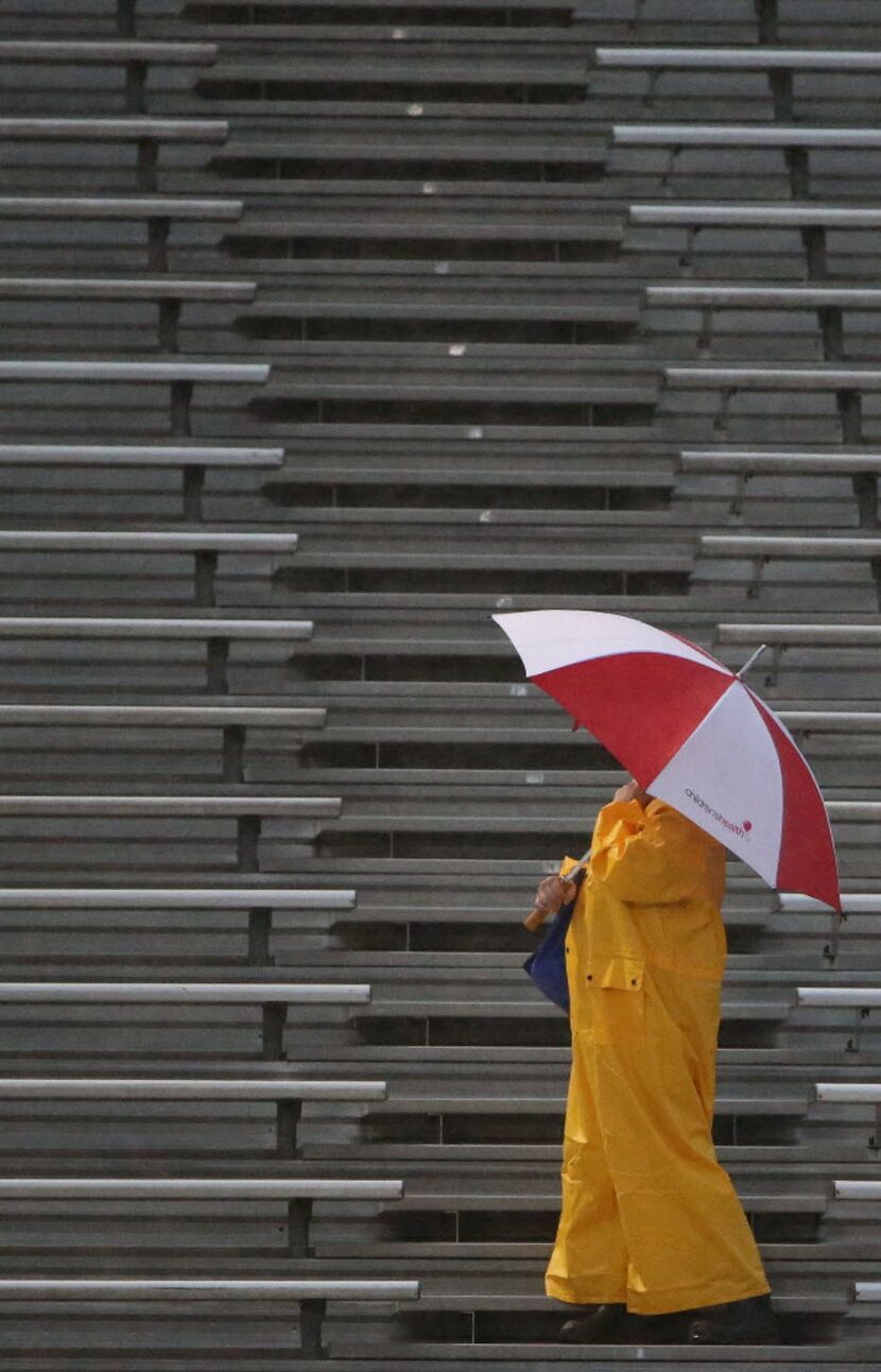 A Midlothian fan stands in the first half during a high school football game between...