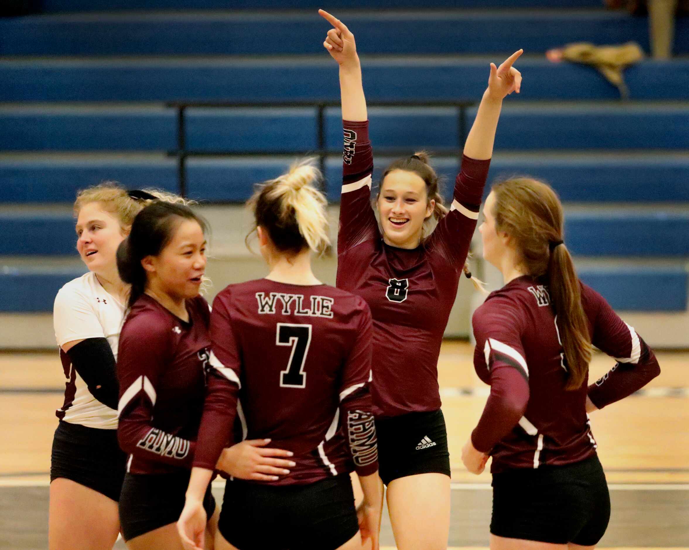 Wylie High School middle blocker Abi Williams (8) celebrates with team mates as they score a...