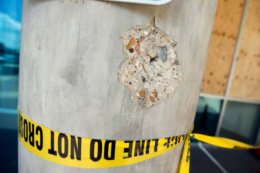  A concrete column outside Dallas police headquarters bears the mark of a bullet fired by...