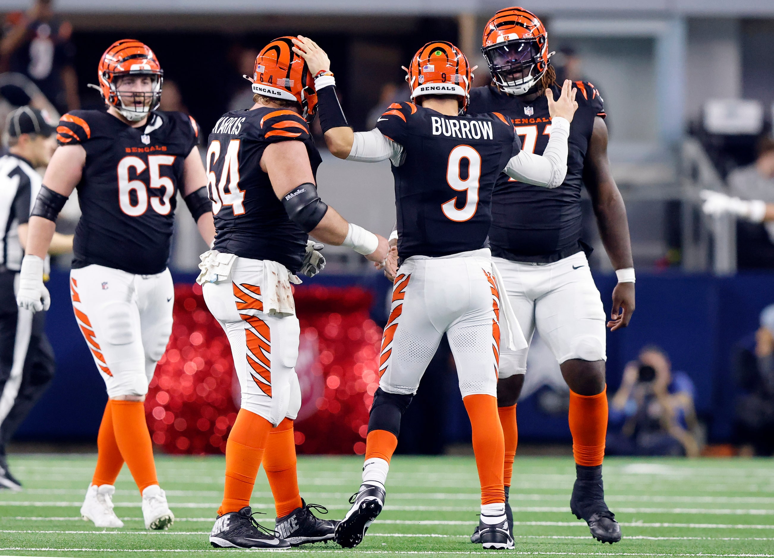 Cincinnati Bengals quarterback Joe Burrow (9) congratulates his lineman after throwing the...