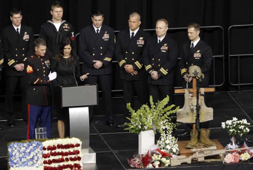 Taya Kyle is consoled by a member of the military as she gets emotional while speaking about...