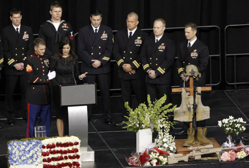 Taya Kyle is consoled by a member of the military as she gets emotional while speaking about...