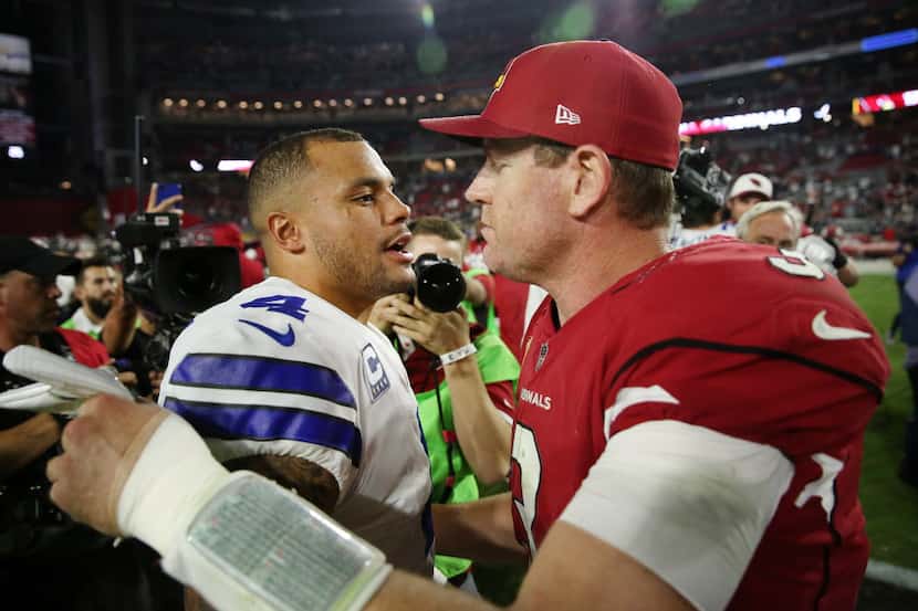 Dallas Cowboys quarterback Dak Prescott (4) speaks with Arizona Cardinals quarterback Carson...