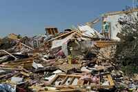 A woman stands in a damaged home on Sunday, May 26, 2024, in Celina, Texas, after a tornado...