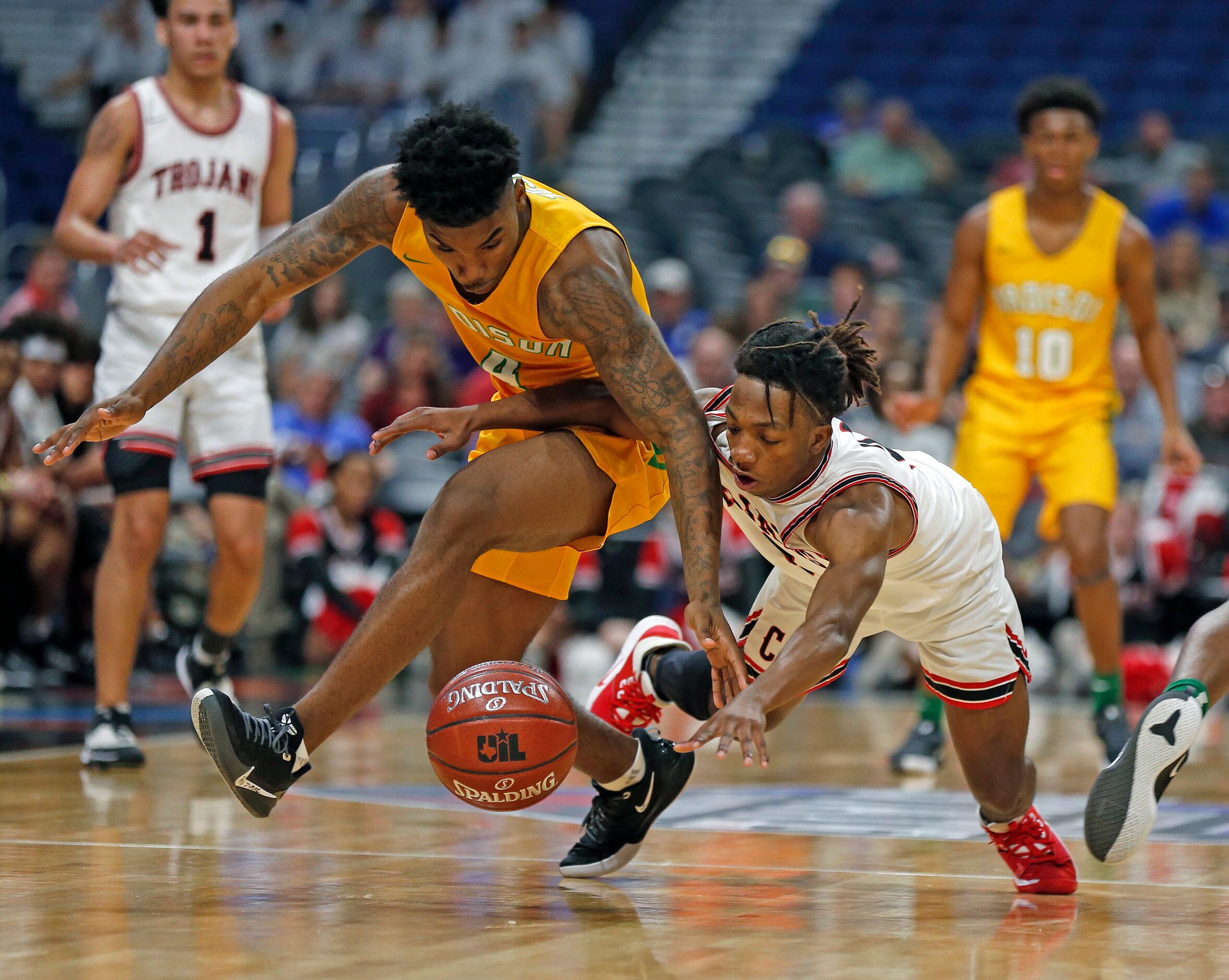 Madison guard Tavorice Weaver #4 fights for a loose ball with Coldspring-Oakhurst guard Tay...