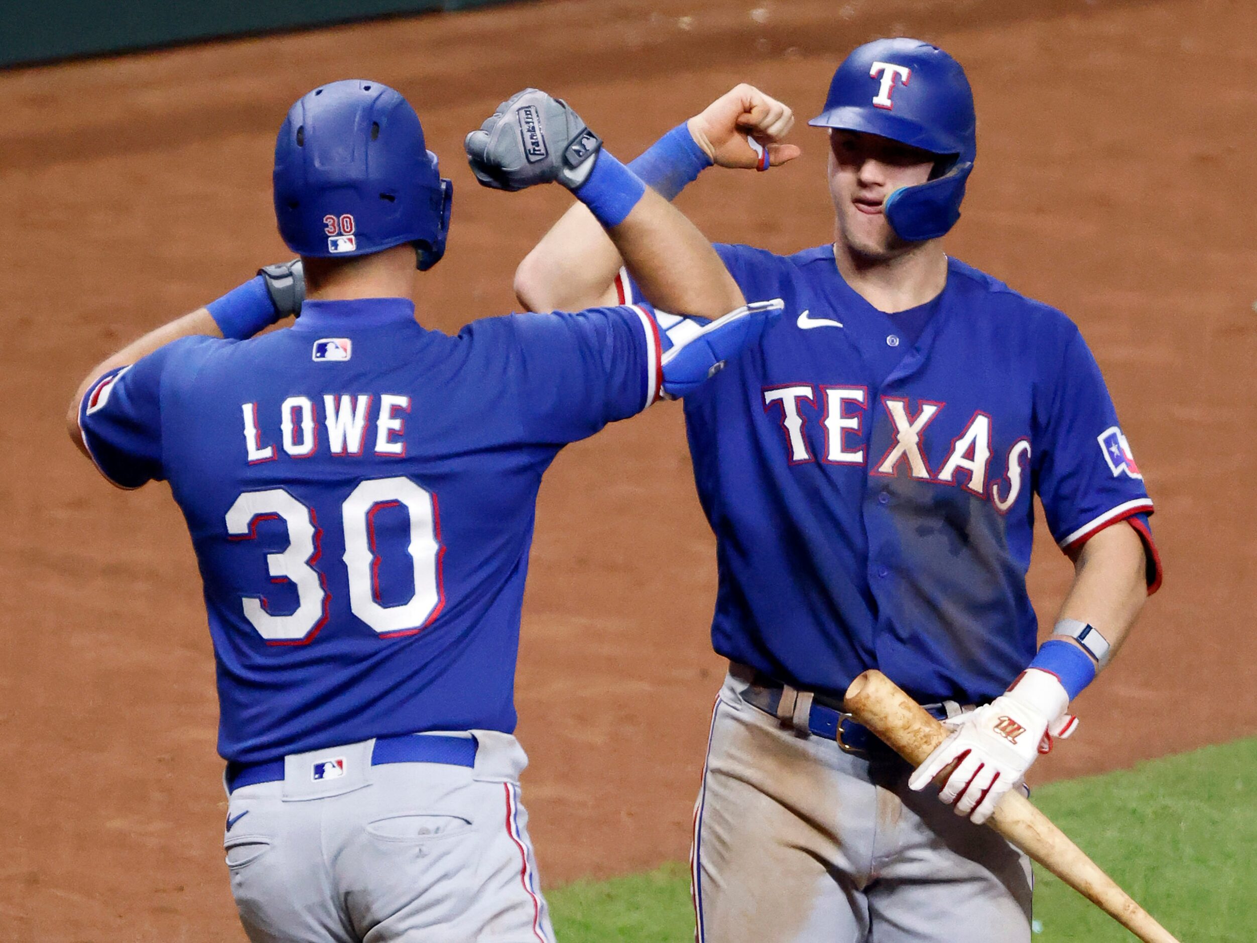 Texas Rangers first baseman Nathaniel Lowe (30) is congratulated on his 2-run homer by...