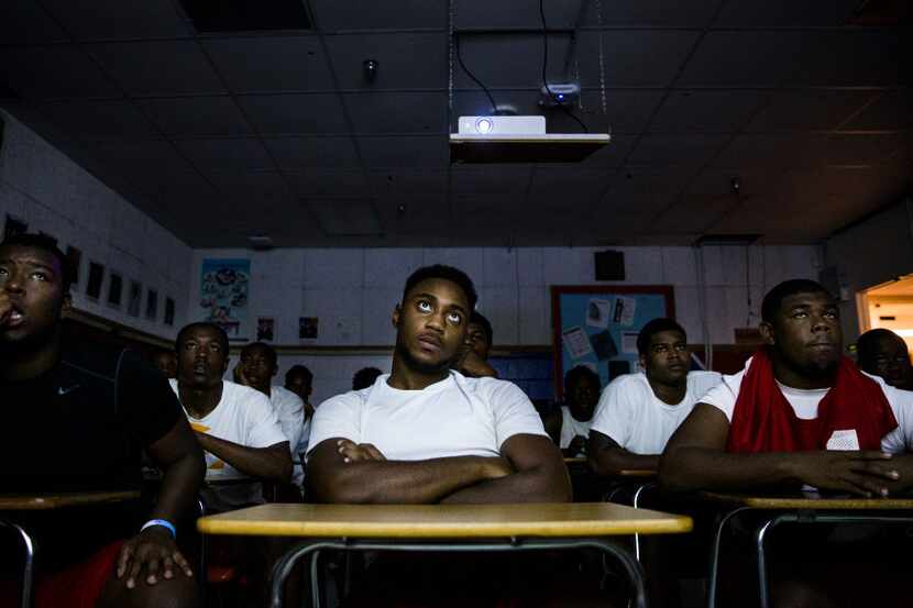 Carter High School defensive football players watch game tape on Monday, August 14, 2017 at...
