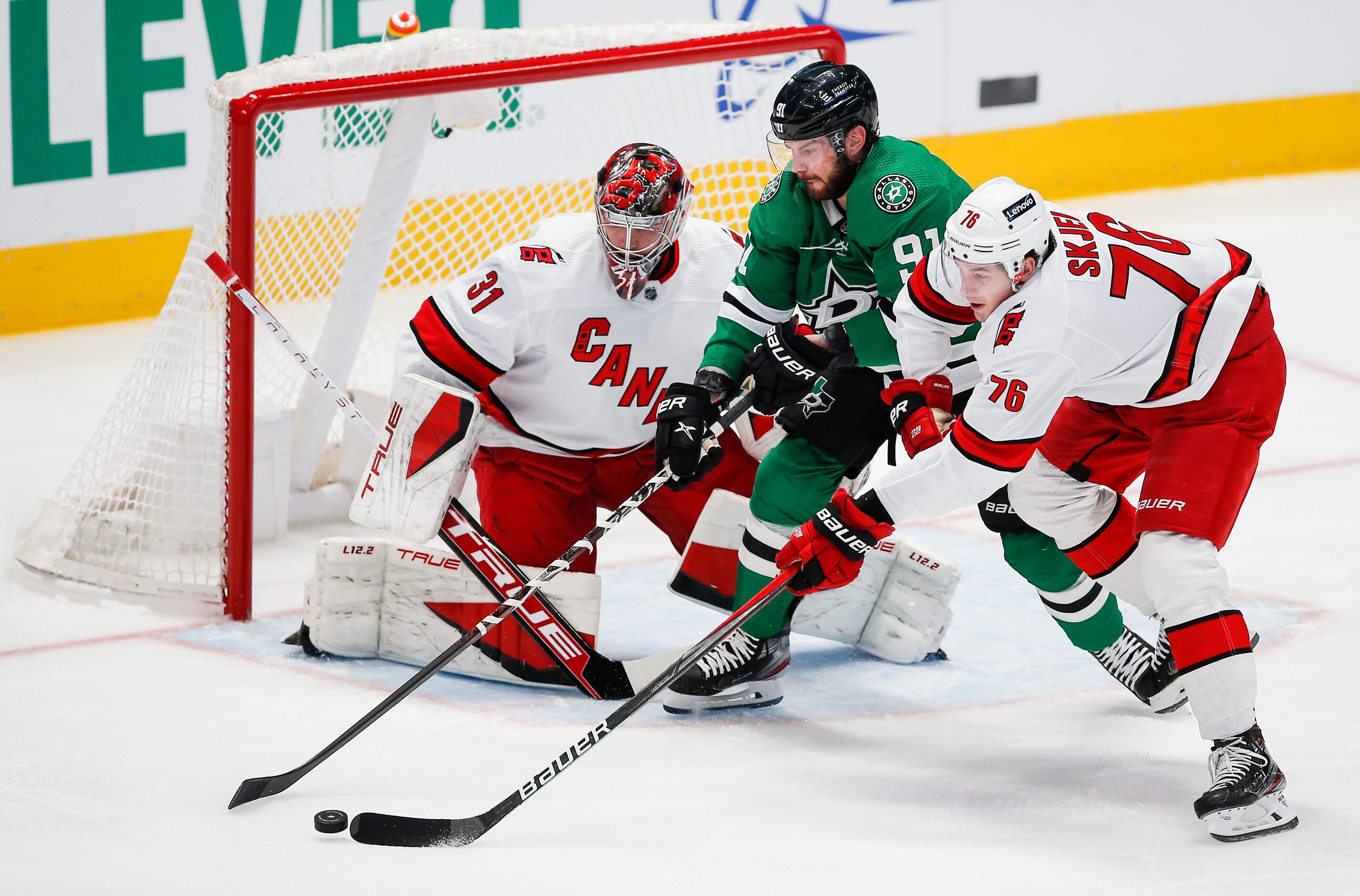 Dallas Stars forward Tyler Seguin (91) battles Carolina Hurricanes defenseman Brady Skjei...