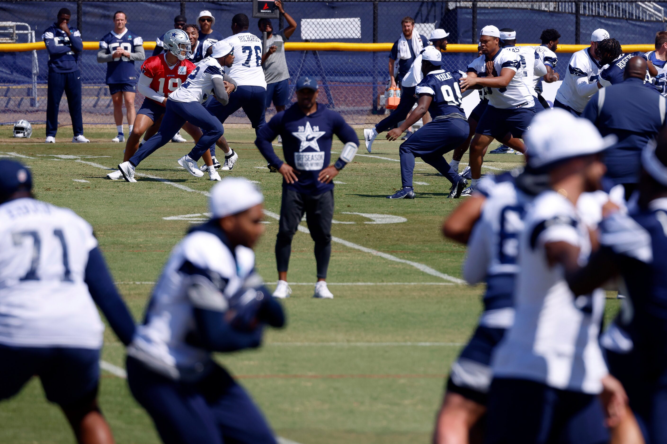 On separate fields, third team quarterback Trey Lance (19) hands the ball off as the ones...