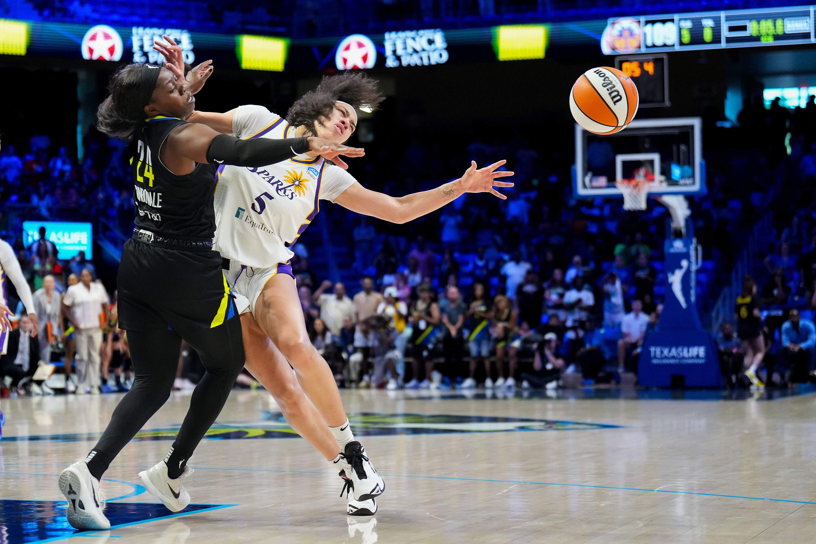 Los Angeles Sparks forward Dearica Hamby (5) is fouled by Dallas Wings guard Arike...