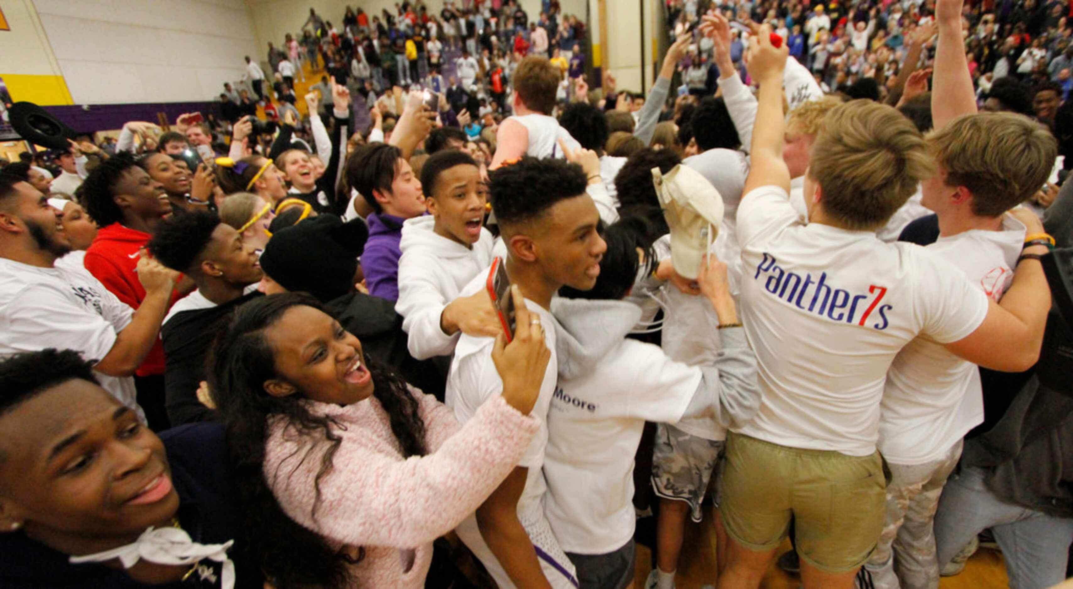 Richardson's Rylan Griffin (3) receives congratulations from fans that stormed the court...