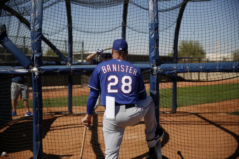 FILE - Texas Rangers manager Jeff Banister watches batting practice during a workout at the...