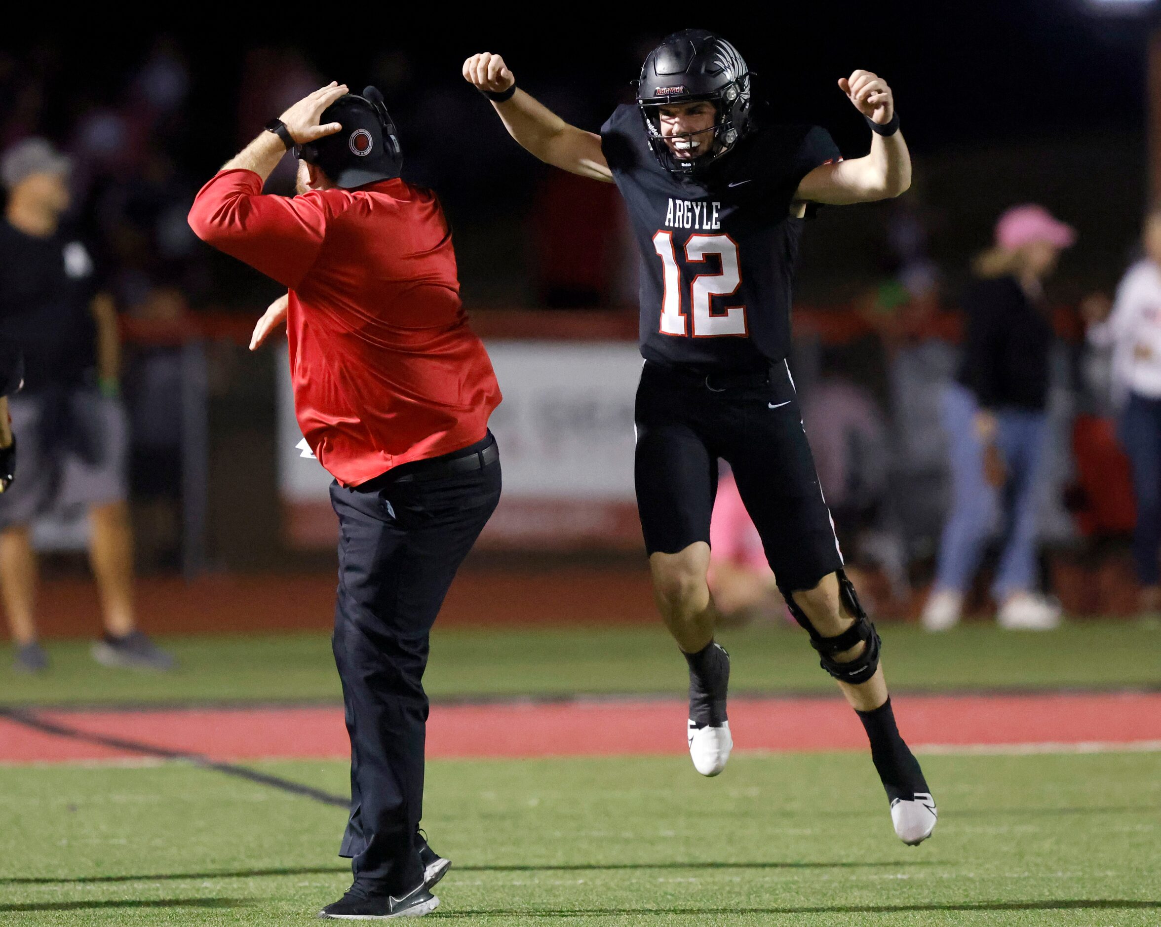 Argyle quarterback John Gailey (12) celebrates his touchdown strike to receiver Will...