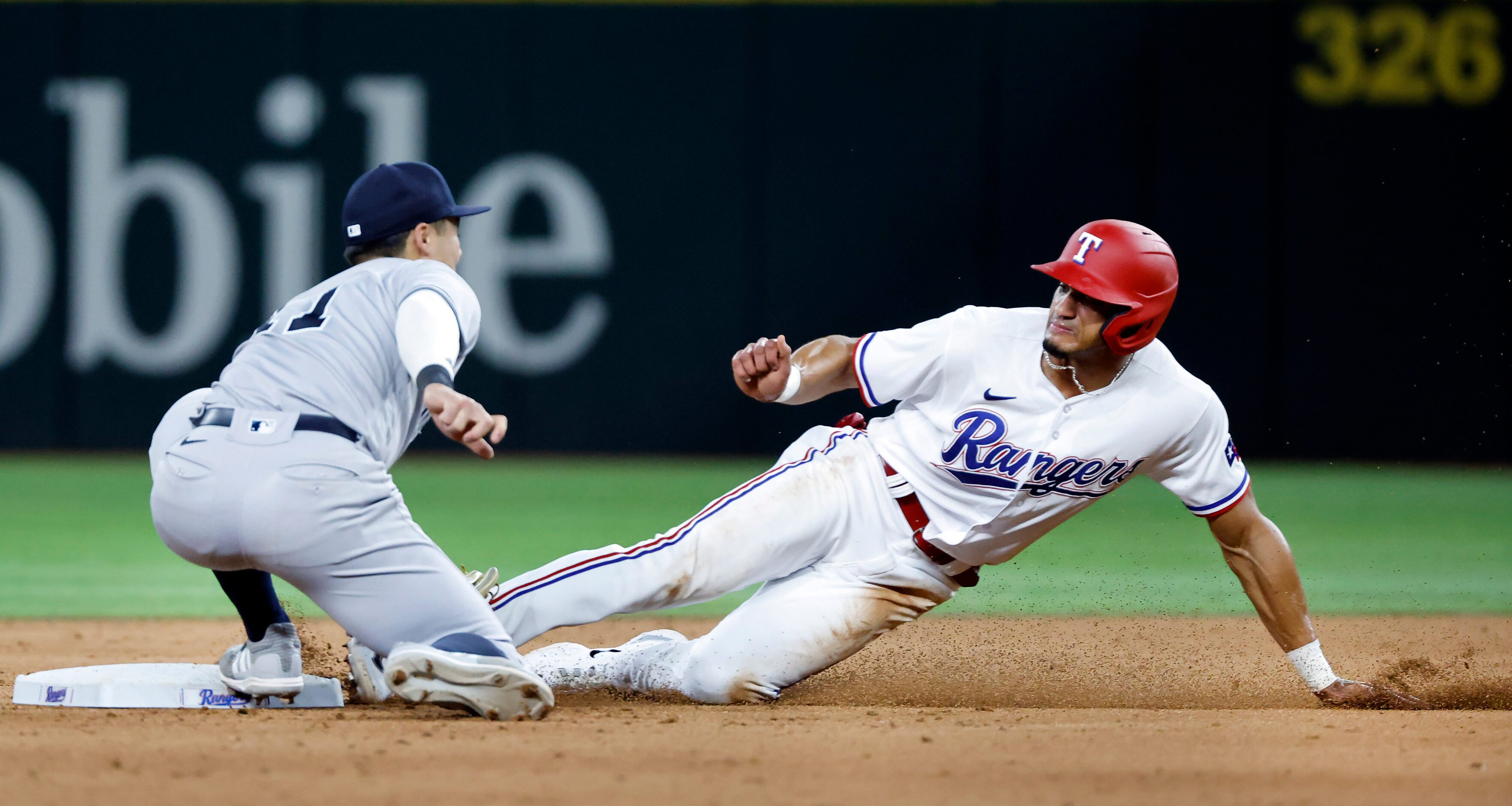 Texas Rangers Bubba Thompson (8) is tagged out by New York Yankees shortstop Anthony Volpe...