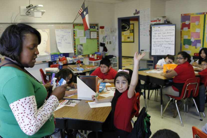 DISD Bethune Elementary fourth-grade teacher Casandra Lott-Woods asks questions during an...
