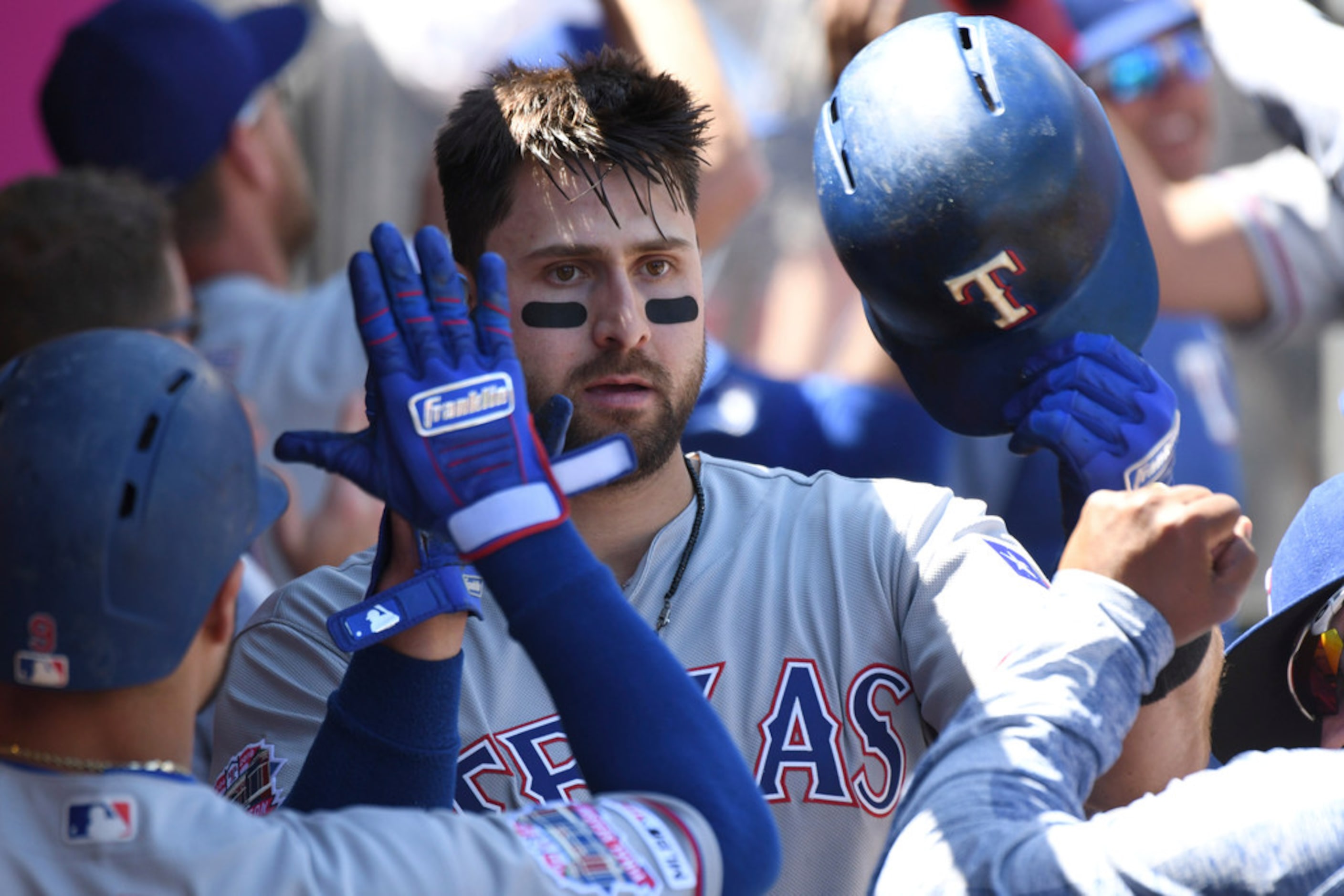 Texas Rangers' Joey Gallo, center, is greeted in the dugout after hitting a two-run home run...