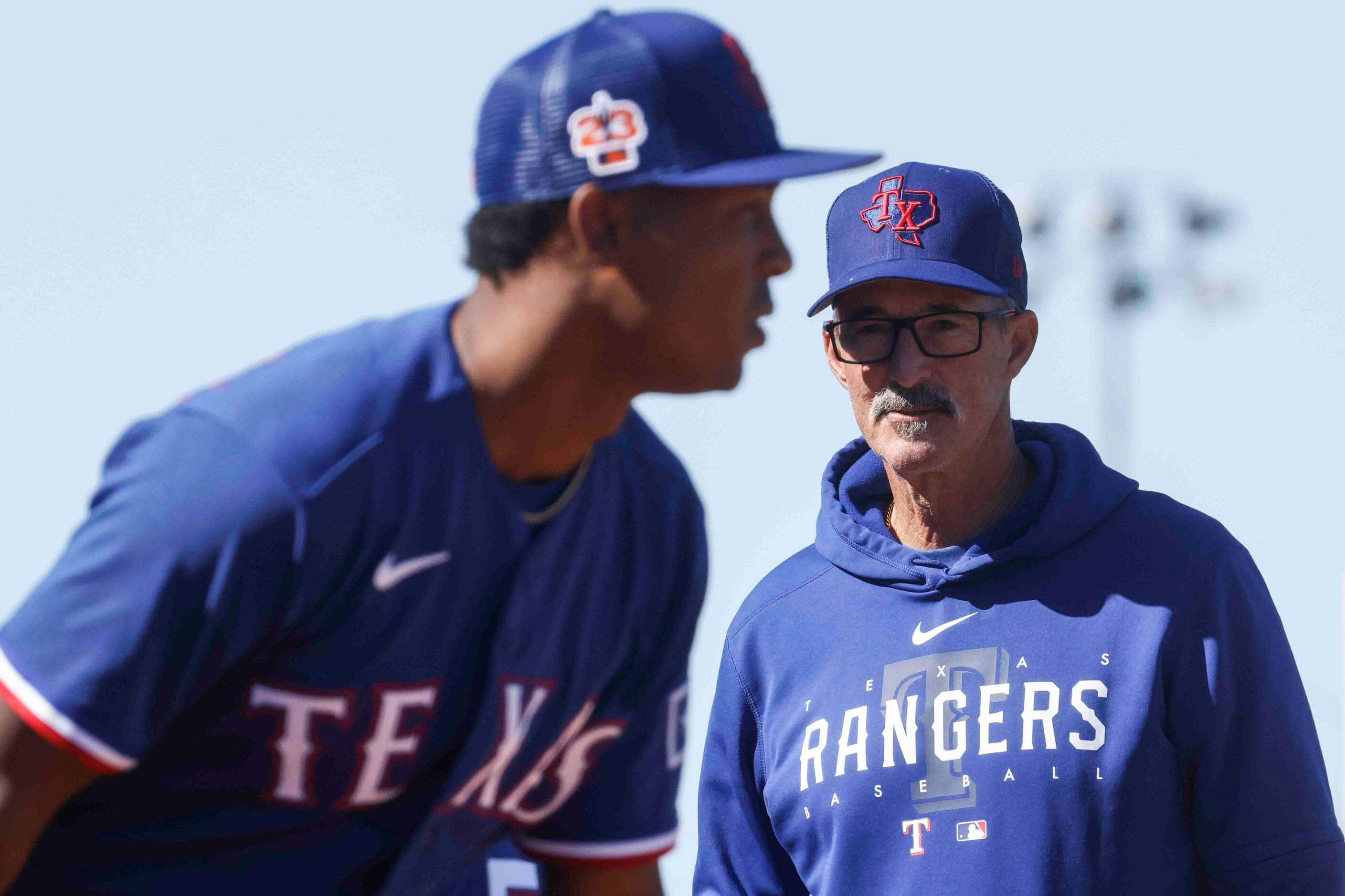 Texas Rangers pitching coach Mike Maddux, right, observes right handed pitcher Jose Leclerc...