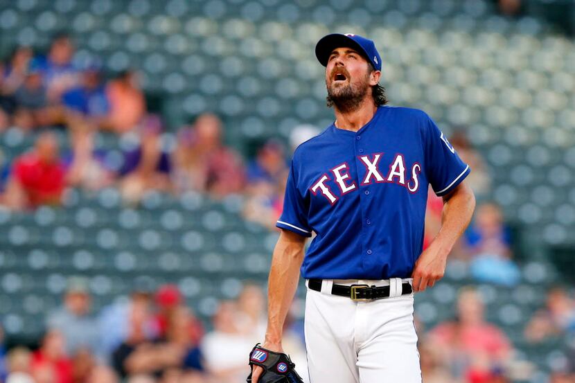 Texas Rangers starting pitcher Cole Hamels (35) takes a moment on the mound as he gets off...