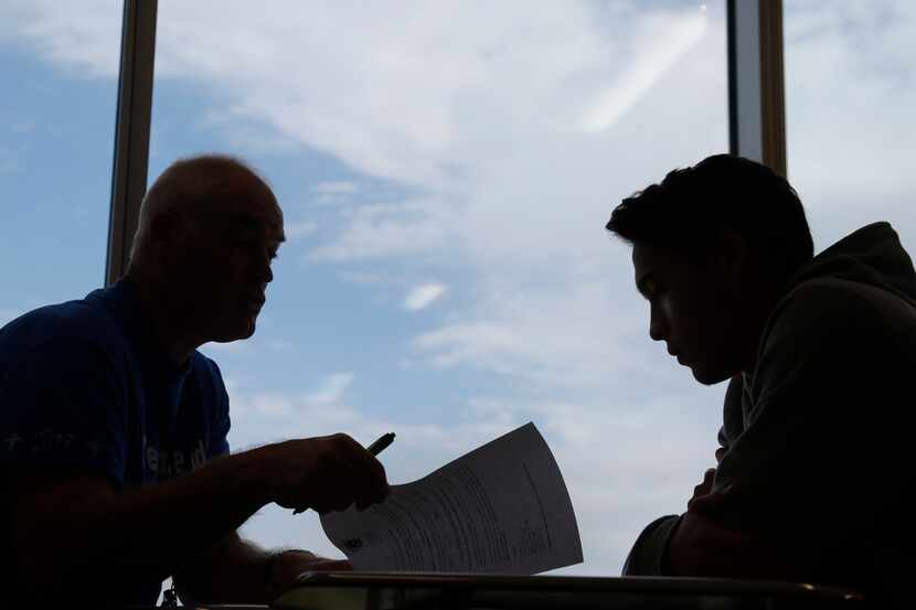 Lead counselor Al Marks (left) talks with Grand Prairie High School student William Jenkins,...