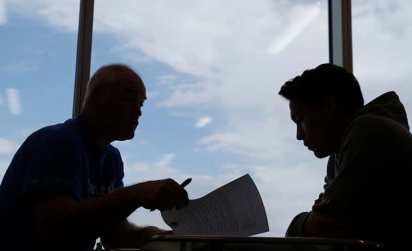 Lead counselor Al Marks (left) talks with Grand Prairie High School student William Jenkins,...