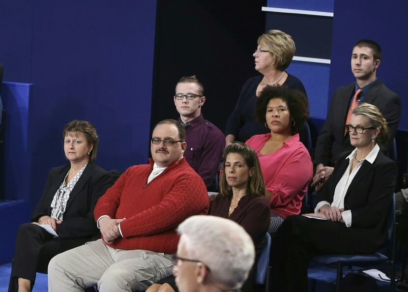 In this file photo dated October 9, 2016 Ken Bone (2nd L) listens to US Democratic nominee...