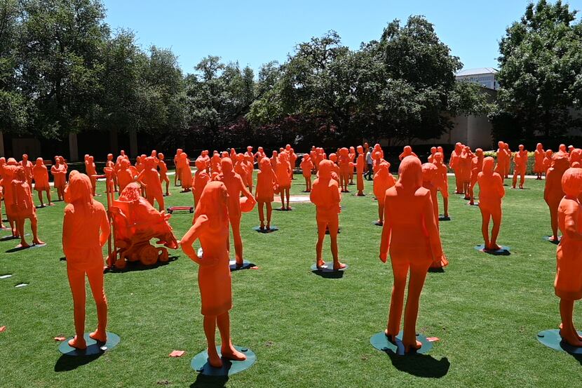 More than 100 statues of women scientists are assembled on the courtyard lawn at NorthPark...
