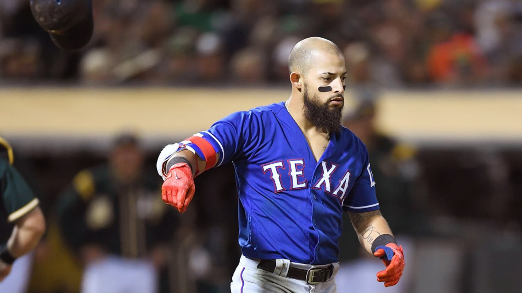 OAKLAND, CA - SEPTEMBER 22:  Rougned Odor #12 of the Texas Rangers reacts by tossing his...