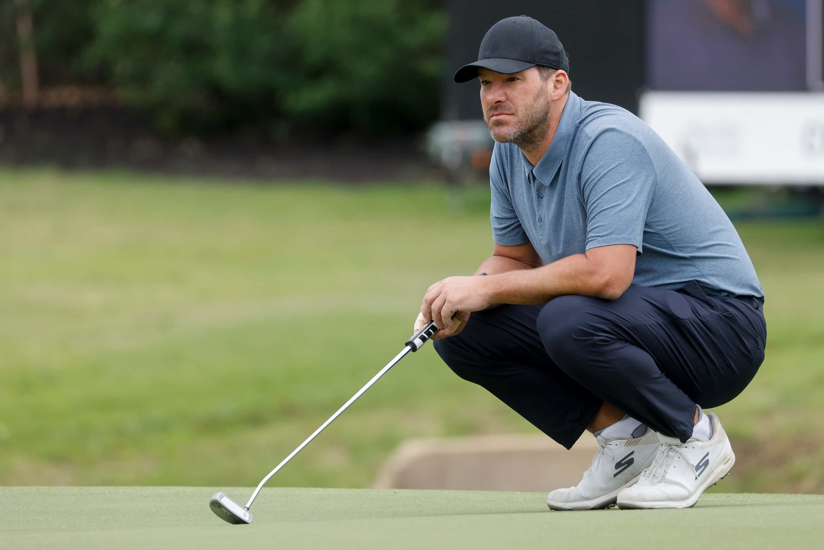 Former Dallas Cowboys quarterback Tony Romo waits to putt on the 17th green during the first...