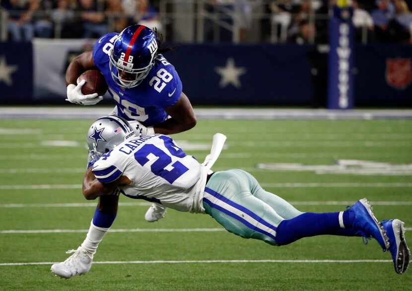 Dallas Cowboys cornerback Nolan Carroll II (24) tackles New York Giants running back Paul...