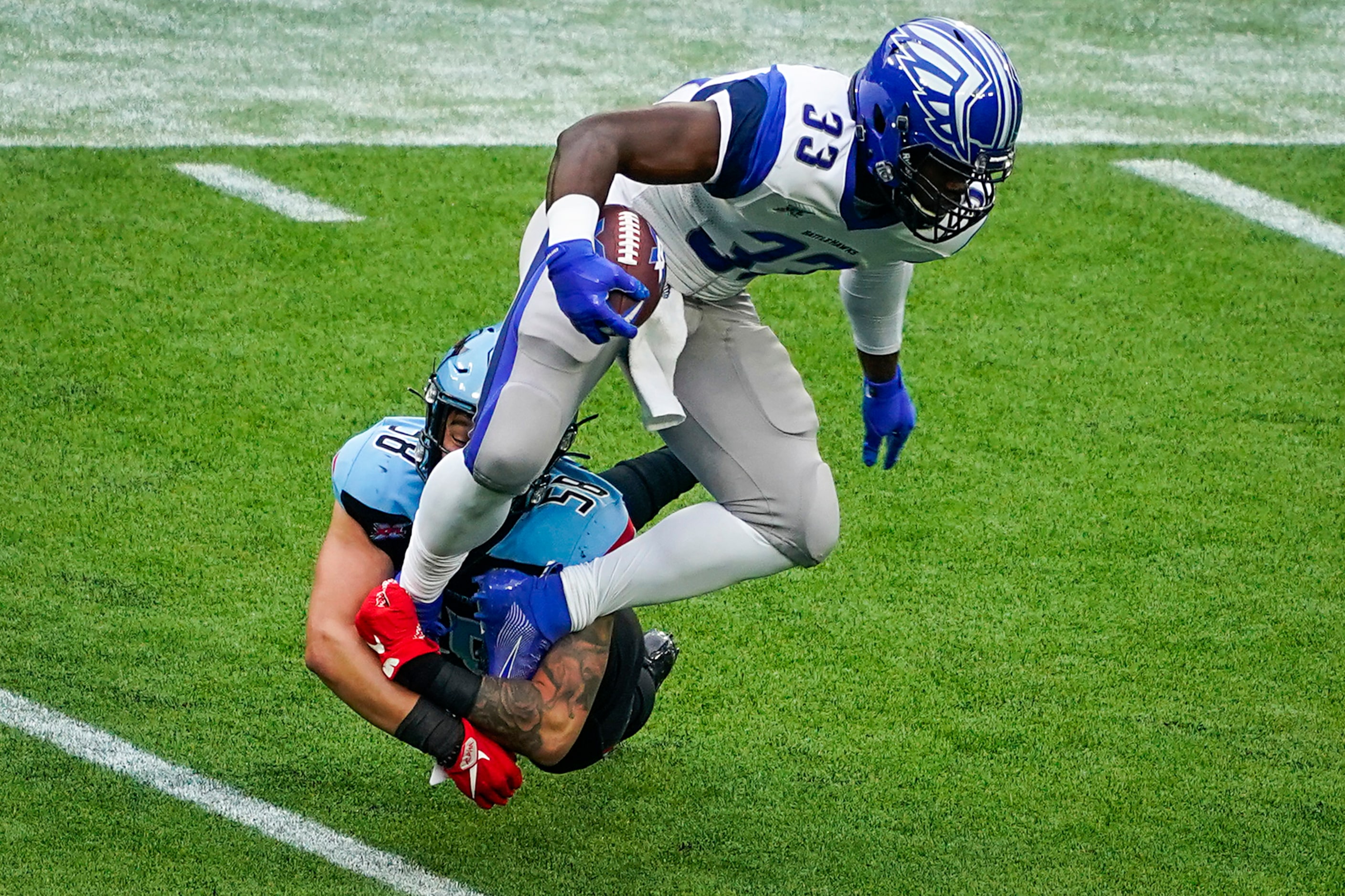 Dallas Renegades linebacker Asantay Brown (58) brings down St. Louis Battlehawks running...