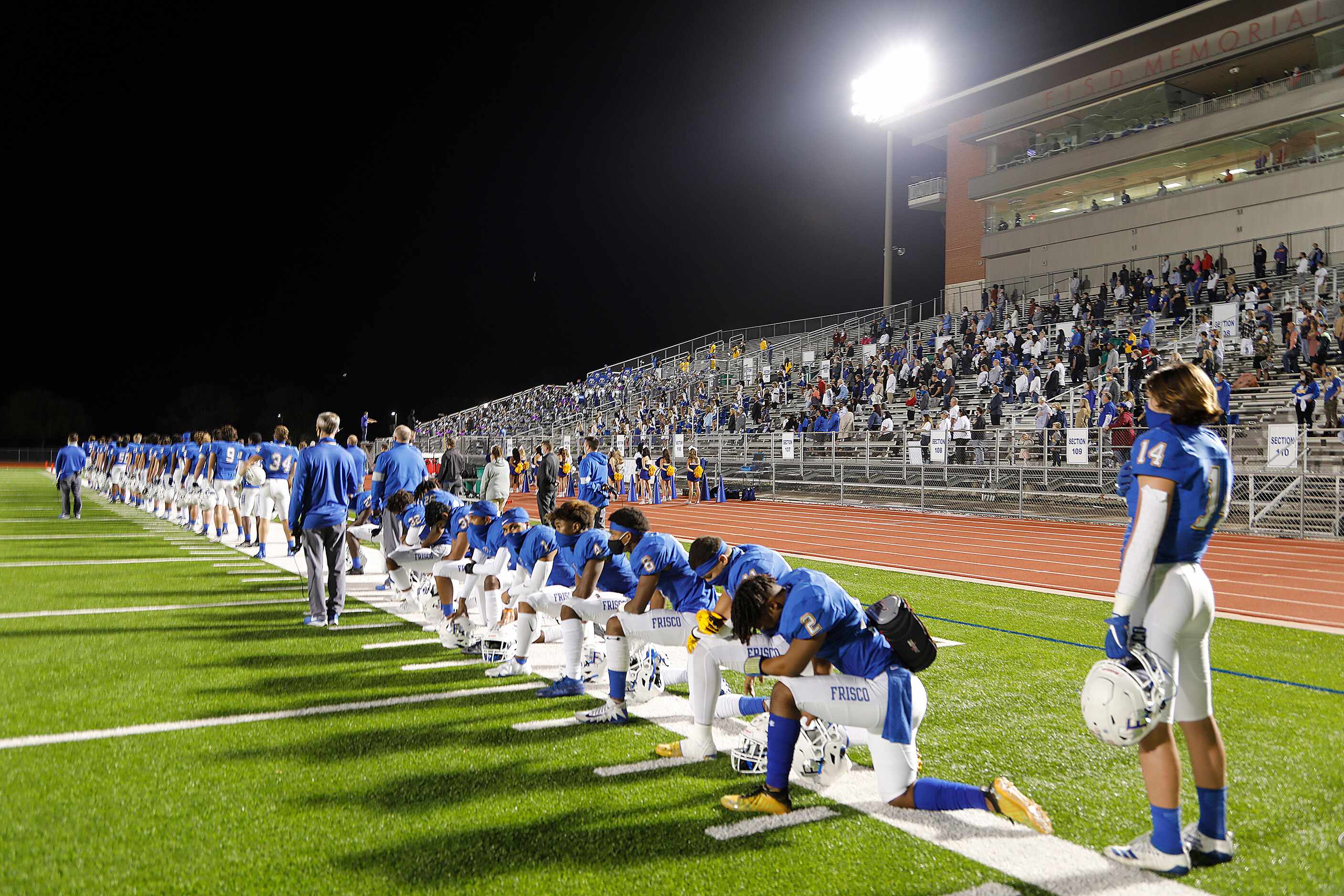 Frisco High School players take a knee during he National Anthem as Frisco High School ...