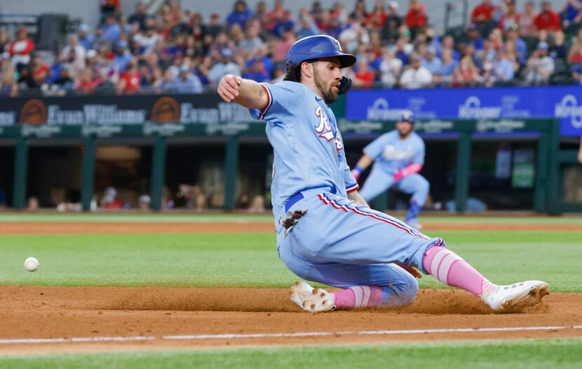 Texas Rangers shortstop Charlie Culberson (2) slides to third off Texas Rangers catcher Jose...