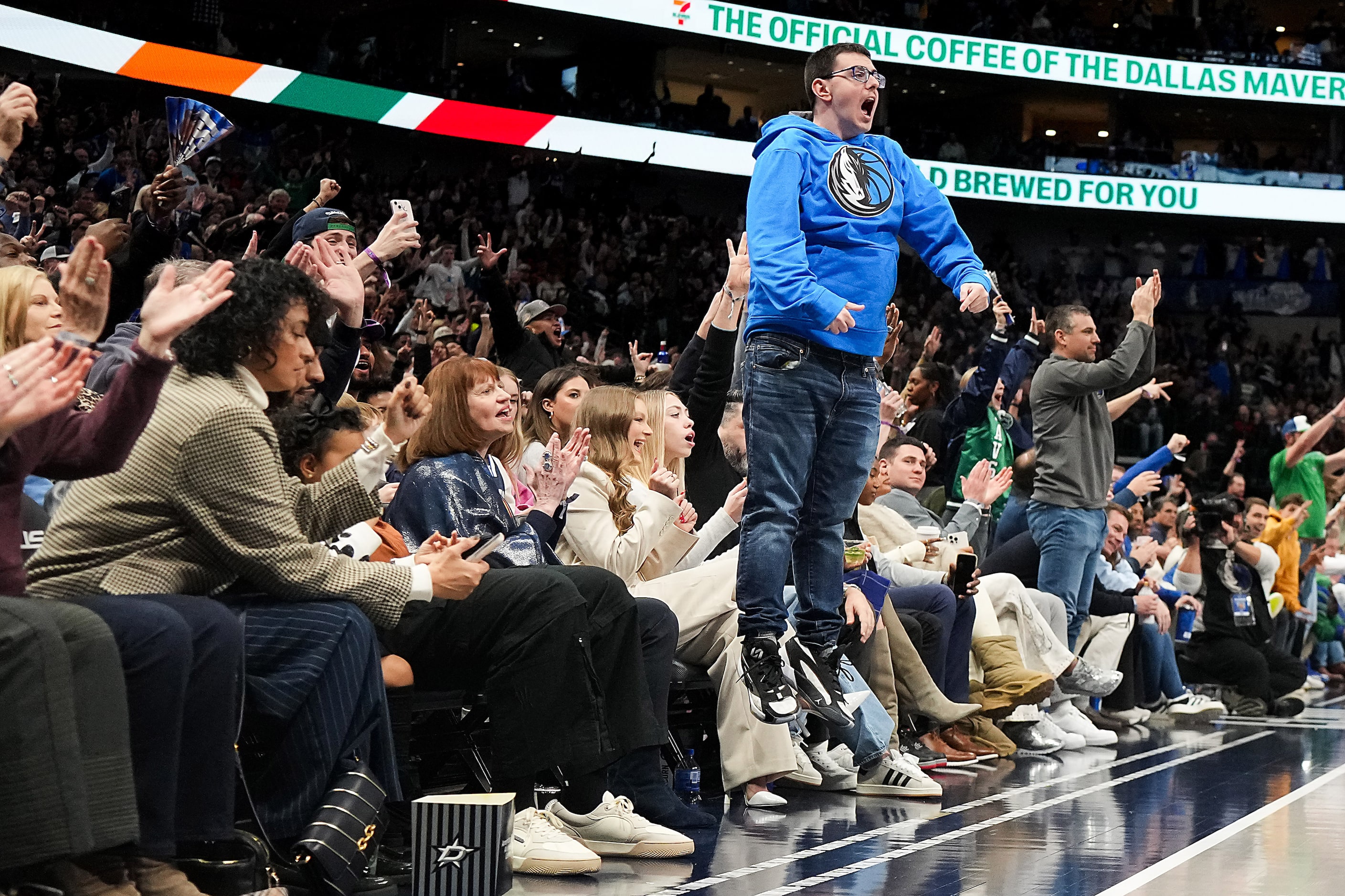 Dallas Mavericks fans celebrate a 3-pointer by guard Klay Thompson during the second half of...